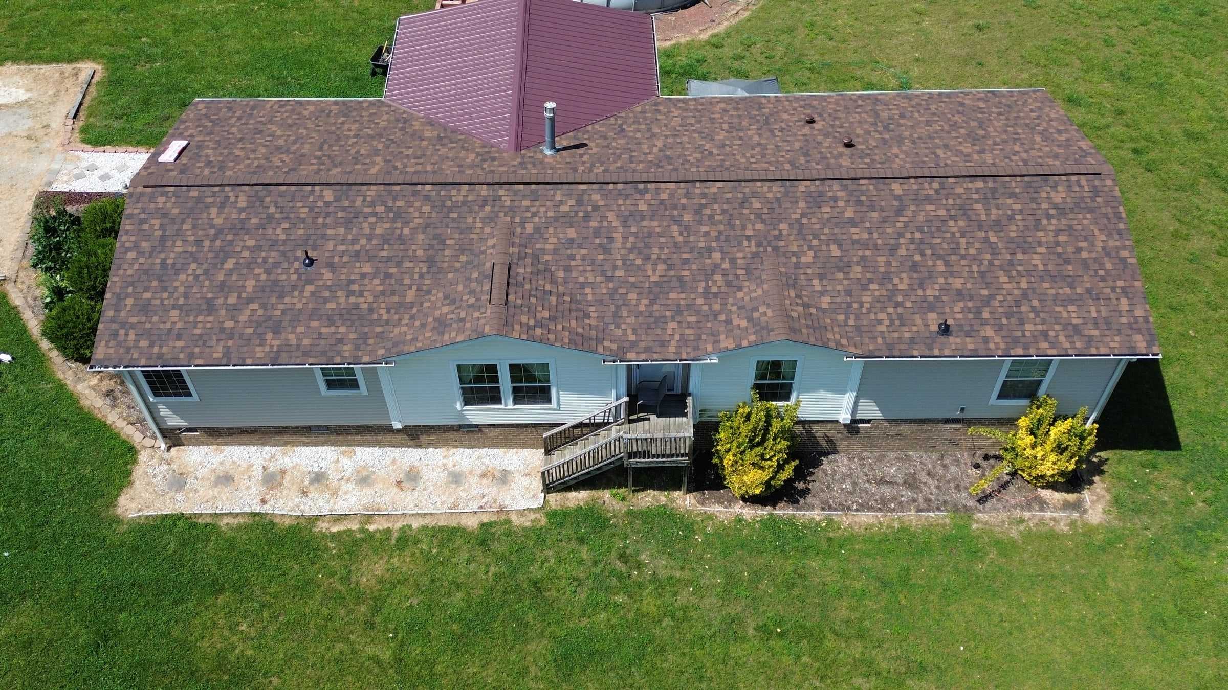 Single-story ranch home with a new brown architectural shingle roof.