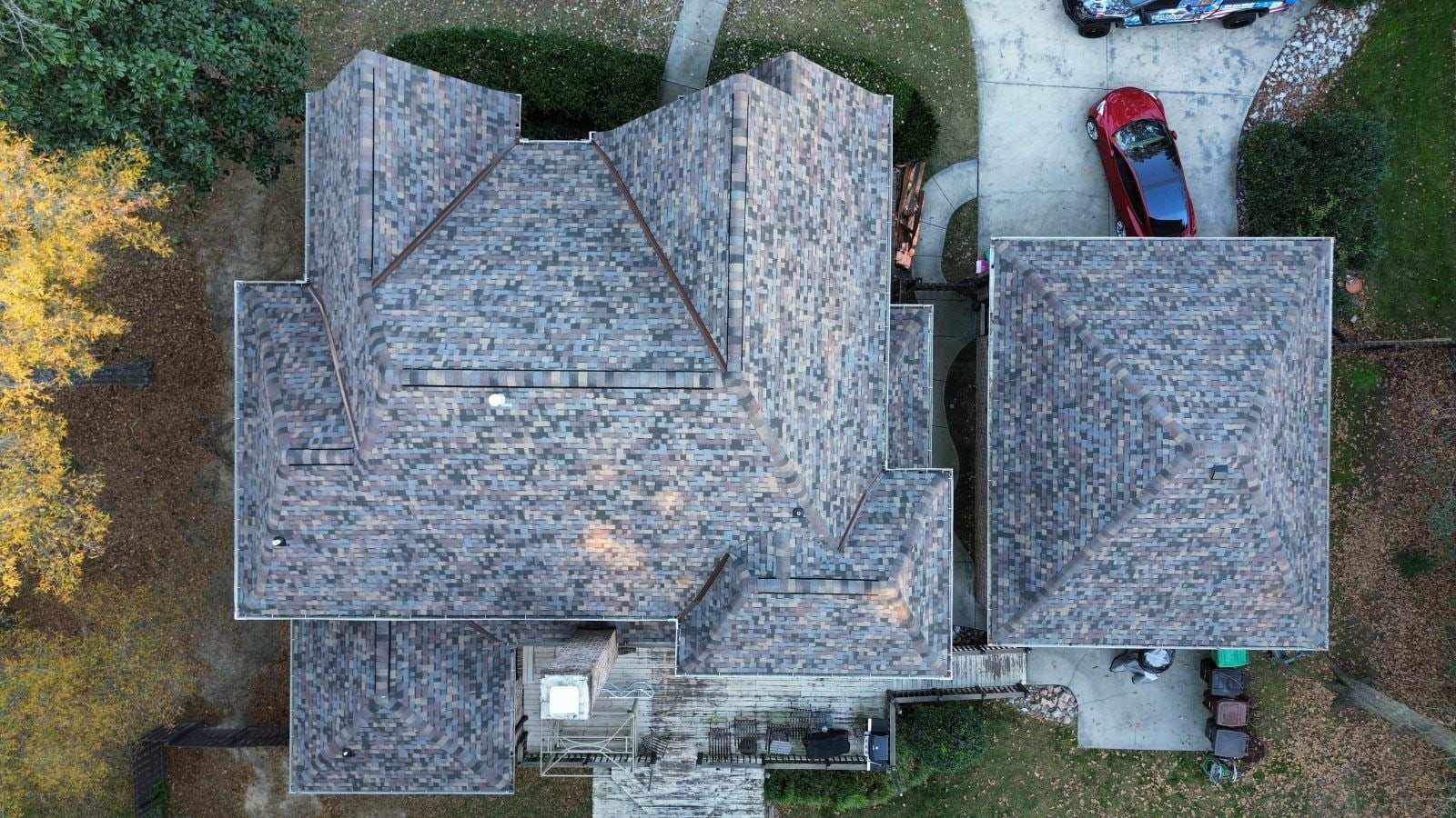 Top-down view of a multi-colored Owens Corning Duration Designer shingle roof in Summer Harvest.